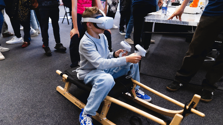 Mit VR-Brille und Controllern entsteht ein virtuelles Rodelerlebnis