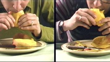 Zwei Personen beim Essen einer Mango