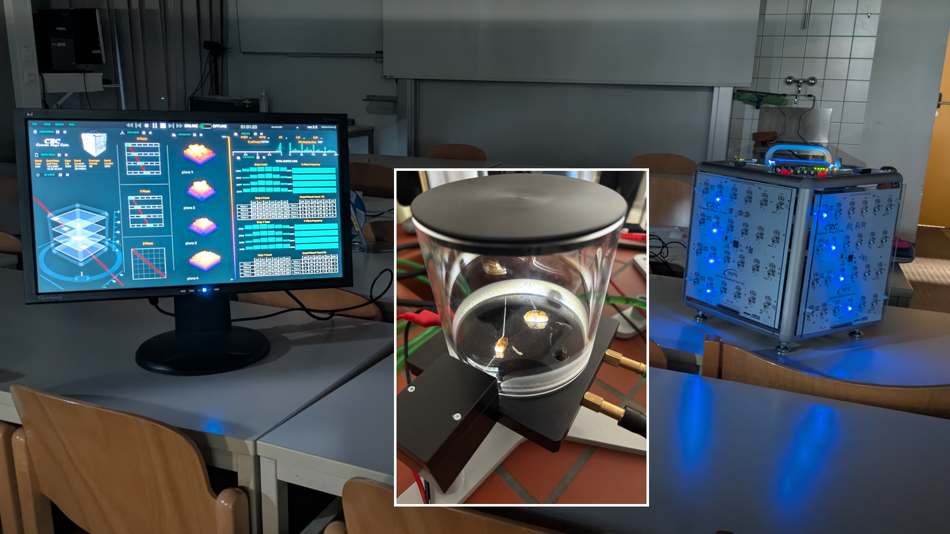 Abbildung einer Nebelkammer (Mitte) sowie des Cosmic-Ray Cubes (rechts) mit Ereignis-Display